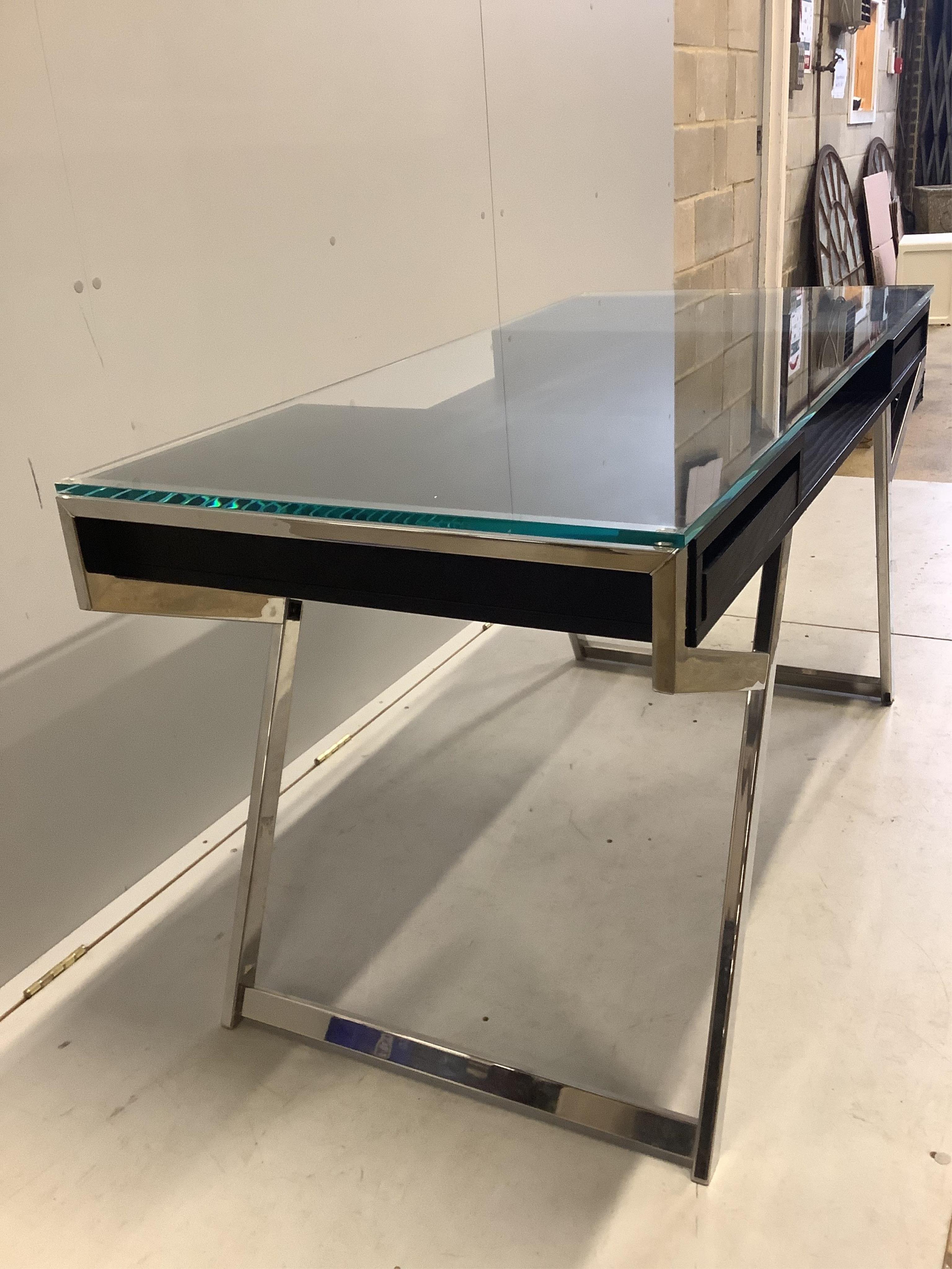 A Contemporary ash and chrome glass topped desk, width 140cm, depth 65cm, height 75cm. Condition - fair